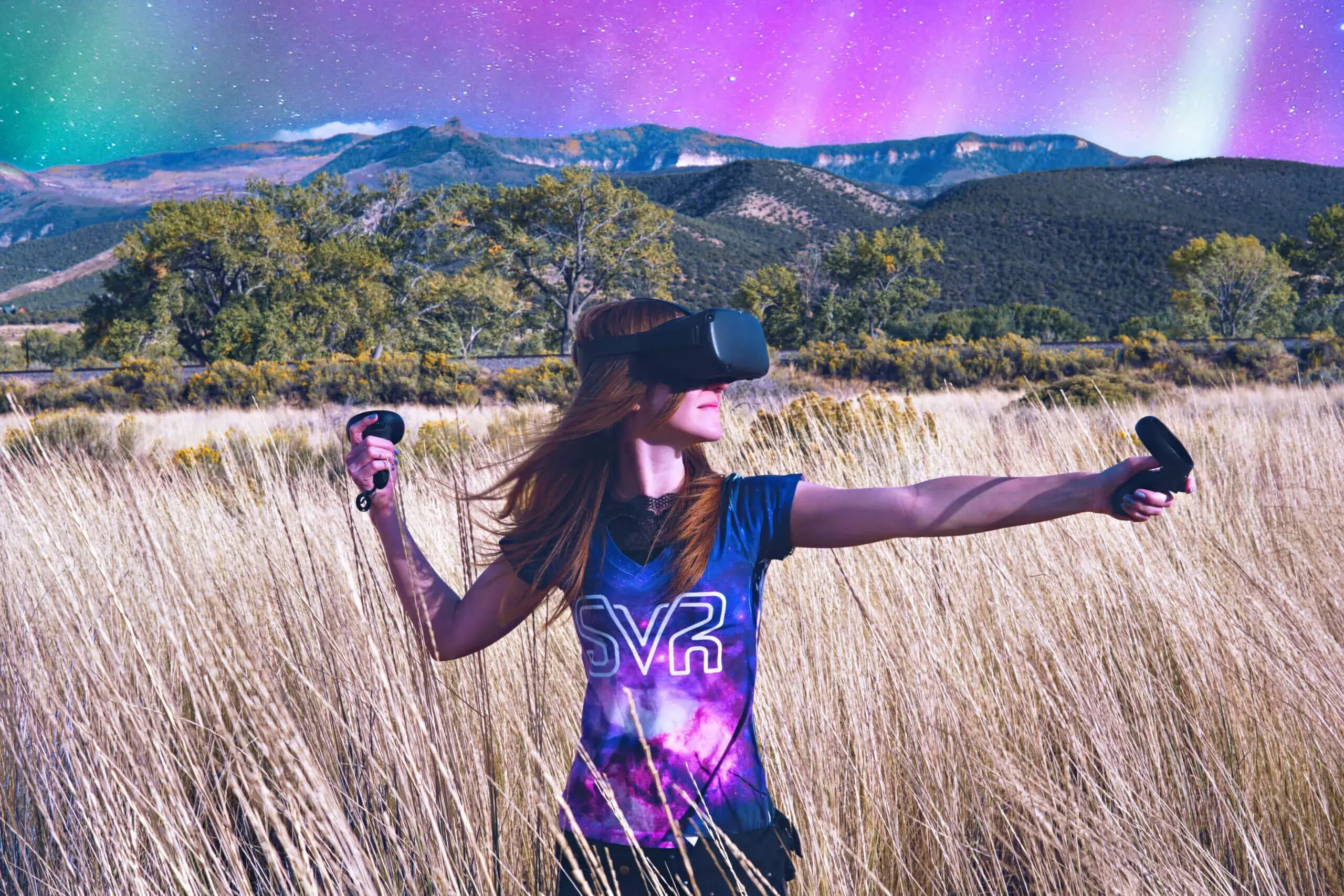 woman wearing Oculus headset and controllers in the middle of tall grasses